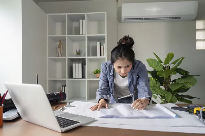 Framed Print : Focused Engineer Analyzes Blueprints Print Framed Print : Focused Engineer Analyzes Blueprints Print