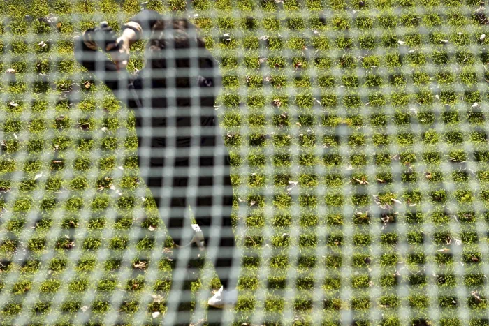 Framed Print : Golfer Training on Driving Range Behind a Net Print Framed Print : Golfer Training on Driving Range Behind a Net Print
