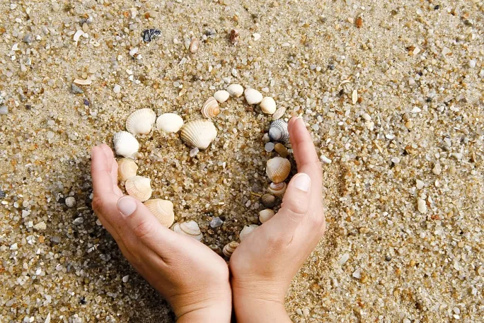 Framed Print : Hands Surrounding a Heart of Shells Print