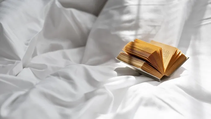 Framed Print : High Angle Print of Book on Bed Sheet
