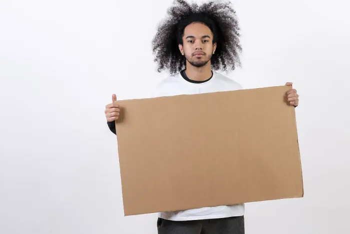 Framed Print : Young Man Holding Sign Print on White Background Framed Print : Young Man Holding Sign Print on White Background