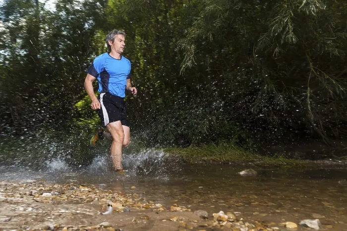Framed Print : Jogger running through a stream, Winterbach, Germany Print