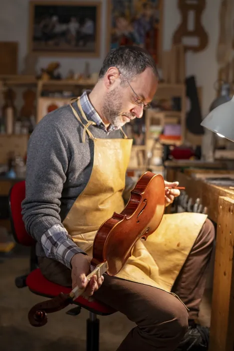 Framed Print : Man Examining a Violin Print Framed Print : Man Examining a Violin Print