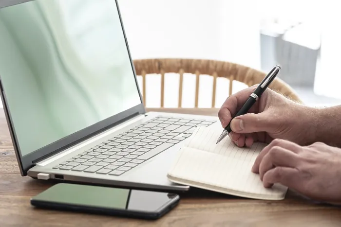 Framed Print : Man Taking Notes on Paper While Using Laptop Computer Print Framed Print : Man Taking Notes on Paper While Using Laptop Computer Print
