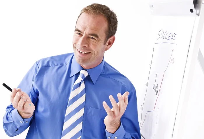Framed Print : Manager Smiling Print - Standing in Front of a Flipchart Framed Print : Manager Smiling Print - Standing in Front of a Flipchart