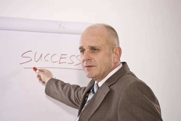 Framed Print : Manager Standing in Front of a 'Success' Flip Chart Print Framed Print : Manager Standing in Front of a 'Success' Flip Chart Print