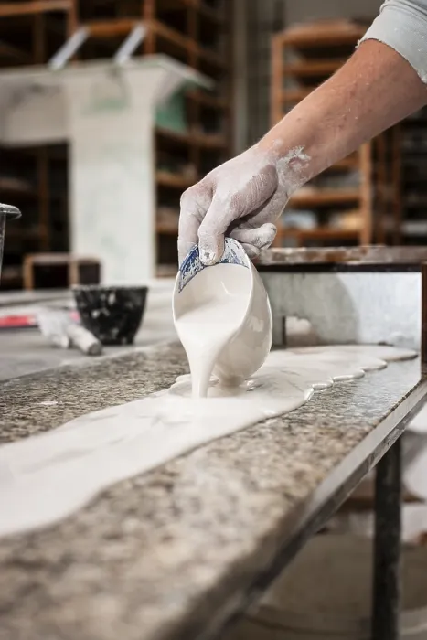 Framed Print : A Plasterer Pours Plaster onto a Workbench Print Framed Print : A Plasterer Pours Plaster onto a Workbench Print