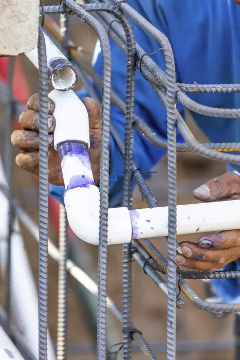 Framed Print : Plumber Installing PVC Pipe Print at Construction Site Framed Print : Plumber Installing PVC Pipe Print at Construction Site