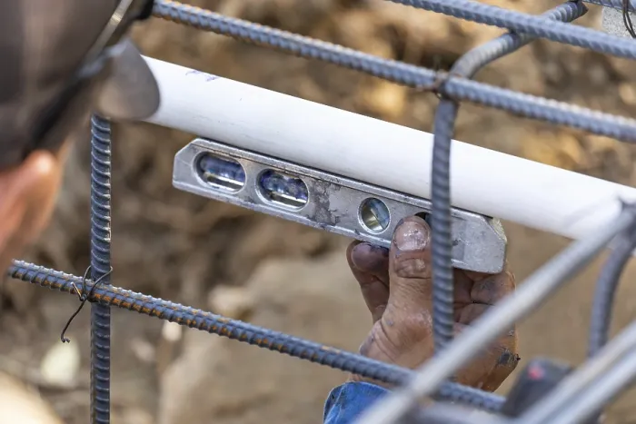 Framed Print : Plumber using level while installing PVC pipe Print Framed Print : Plumber using level while installing PVC pipe Print