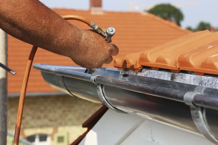 Framed Print : Roofer doing tinsmith work on a gutter Print Framed Print : Roofer doing tinsmith work on a gutter Print