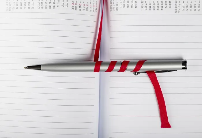 Framed Print : Silver Pen on Opened Notebook Print with Red String