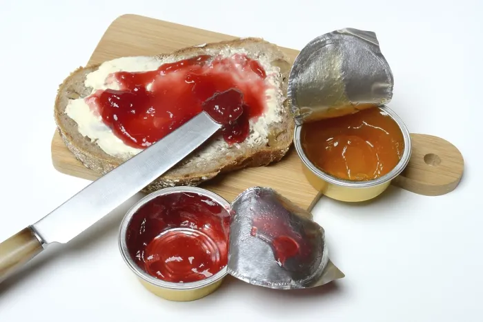 Framed Print : Slice of bread with jam and jam in portion pack Print Framed Print : Slice of bread with jam and jam in portion pack Print