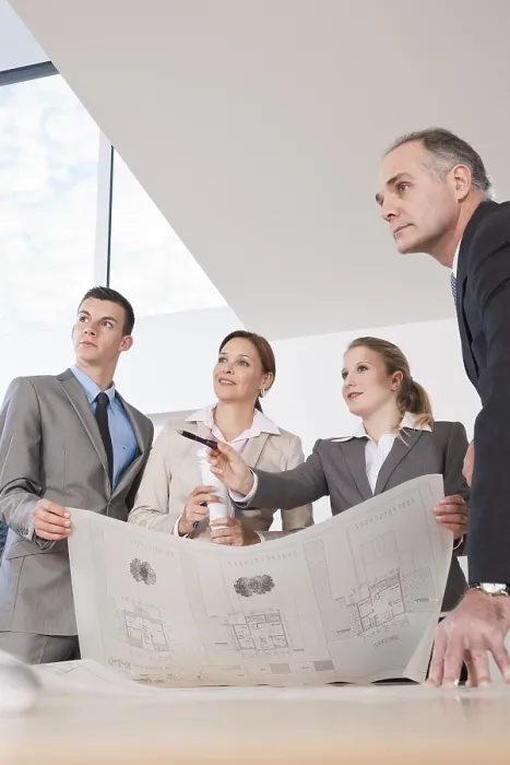 Framed Print : Team of Four Architects Discussing a Construction Plan Print Framed Print : Team of Four Architects Discussing a Construction Plan Print