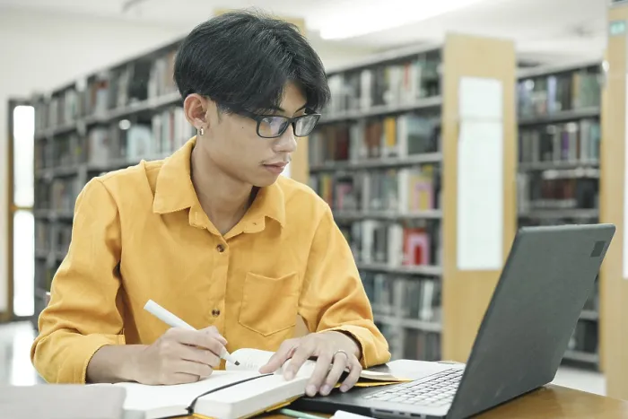 Framed Print : Print of a Thoughtful Young Student Preparing for Class Framed Print : Print of a Thoughtful Young Student Preparing for Class