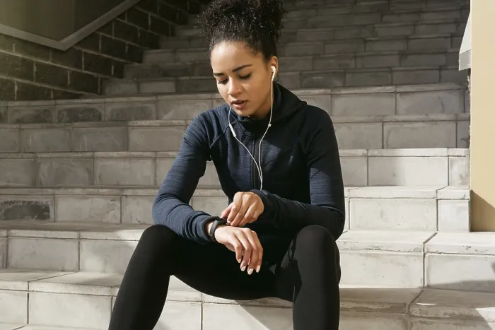 Framed Print : Young Female Runner Checking Pulse with Activity Tracker Print