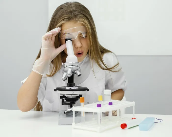 Framed Print : Young Girl Scientist Using Microscope Print
