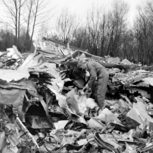 Air crash investigator examining debris
