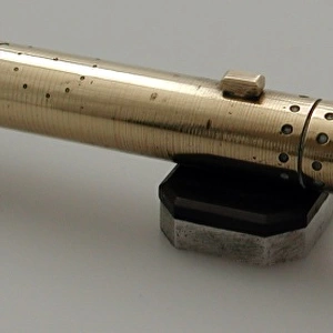 Brass model of torpedo sitting on bakelite and metal stand