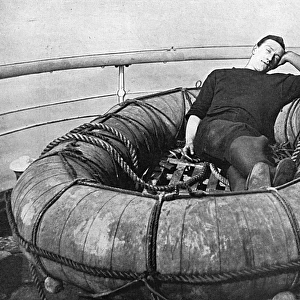 British sailor snoozing on deck, WW1