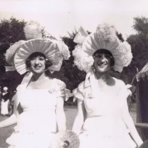 A candid portrait of the Dolly Sisters at a garden party c