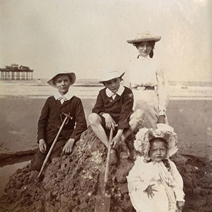 Four children on a sandcastle, Saltburn, North Yorkshire
