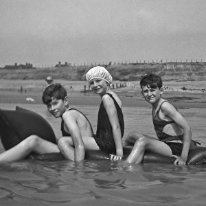 Three children at the seaside