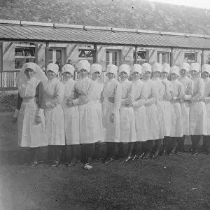 ?Conga? line of 25 nurses, outside single-storey building