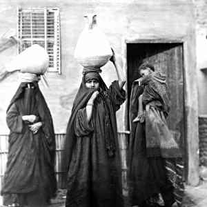 Egyptian women carrying water
