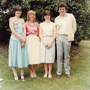 Four English wedding guests in a garden