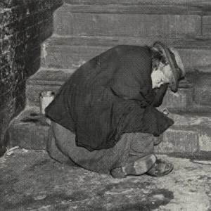 Female tramp asleep on steps, London