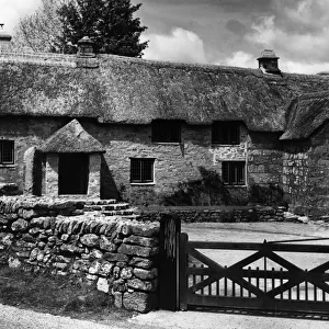 A fine stone-built and thatched farmhouse, at Ponsworthy, Dartmoor, Devonshire