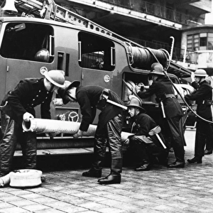 Firefighters with fire engine and appliances, WW2