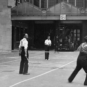 Firefighters playing tennis during a break, London