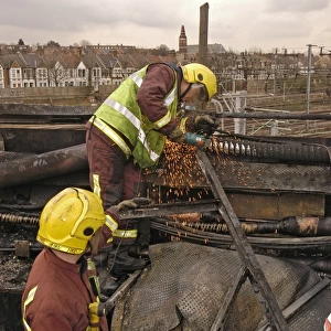 Firefighters using cutting equipment, West London