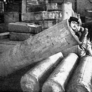 A French soldier lying inside an artillery shell case