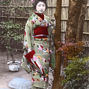 Geisha Girl with patterned kimono and umbrella, Japan