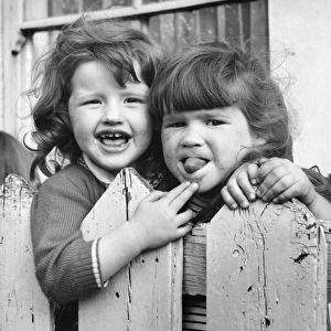 Two girls behind a fence, Balham, SW London