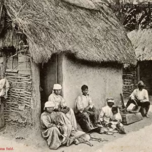 Jamaica - Villagers resting outside house after days work