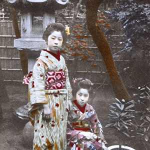 Japan - Two Geisha Girls - posing in an ornamental garden