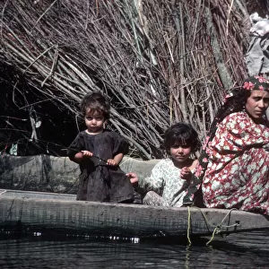 Kashmir, River Jhelum - woman paddles a wooden boat