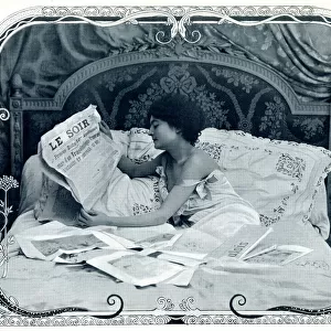 Lady reading the newspaper in bed