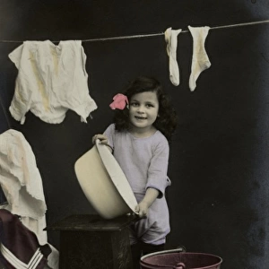 Little girl on a postcard, hanging up the washing