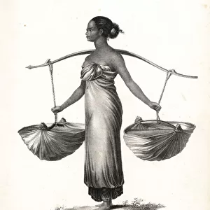 Malay girl with hair tied up carrying baskets from a yoke