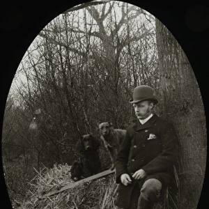 Man leaning against a tree with rifle