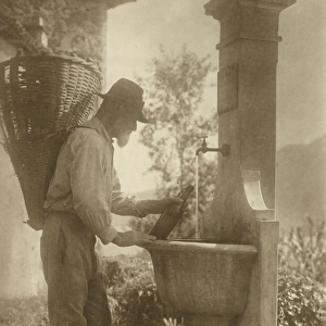 A Man of Ticino re-fills his water bottle - Switzerland