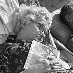 Old lady asleep with paperback book