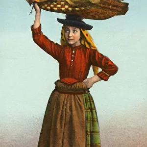 Portuguese girl carrying large flat basket of fish