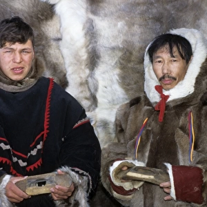 Selkup men in traditional clothes, holding traditional
