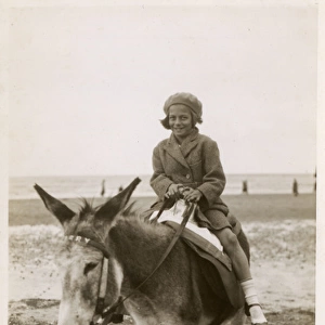 Smiling young girl taking a donkey ride - Margate, Kent