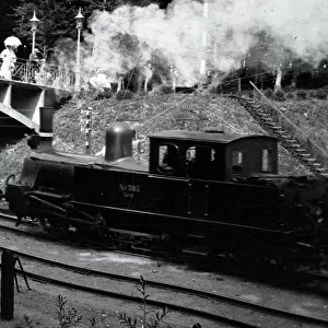 Steam train approaching a bridge